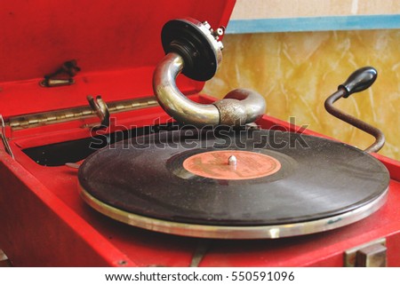 red vintage gramophone with black plate Royalty-Free Stock Photo #550591096