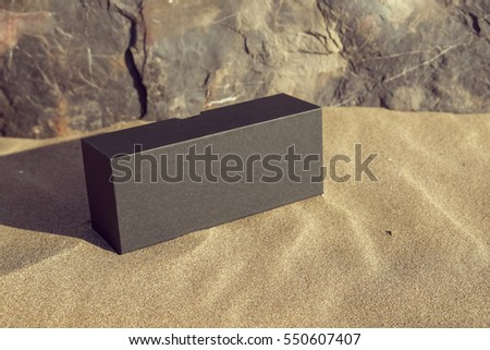 Paper black box on the beach sand