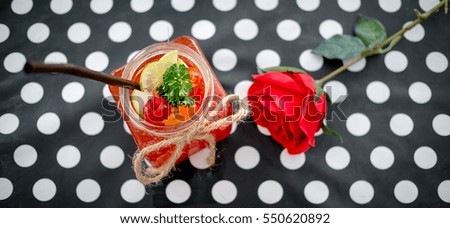 cocktail Smoothies With fruit and Cherry on top and Red Roses flower for Valentine Day . Well being and weight loss concept, berry smoothie.On wooden table.