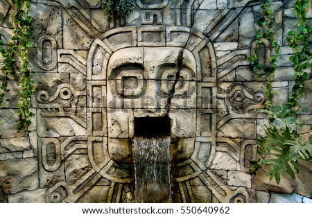 Maya Aztec style stone statue detail Royalty-Free Stock Photo #550640962