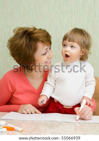 Small drawing girl with mother at home