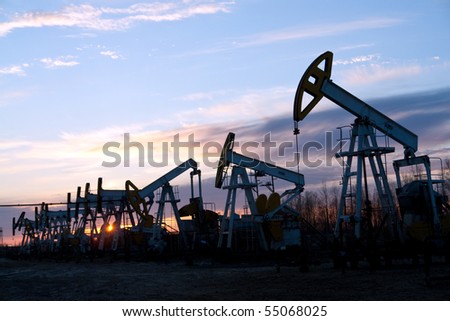 oil pumps at sunset sky  background