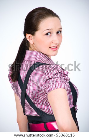 Portrait of beautiful woman dressed in squares elegant shirt and looking back over shoulder