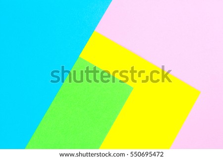 Material design yellow, blue, pink and green paper background. Photo.