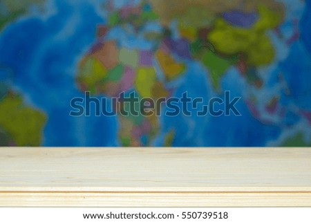 Empty wooden table and blurred map of the world. Background can used for display your products..