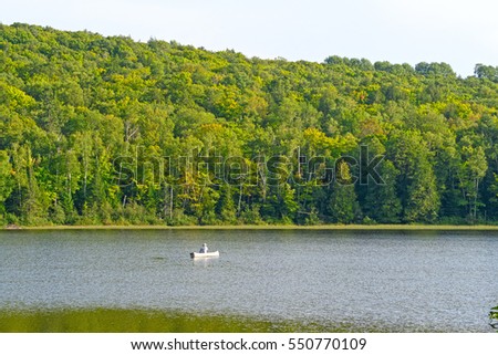 Canoer on a Quiet Lake on Lake of the Clouds in Porcupine Mountains State Park in MIchigan