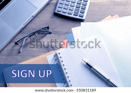 Notebook with calculator, keyboard and pen on table with text SIGN UP