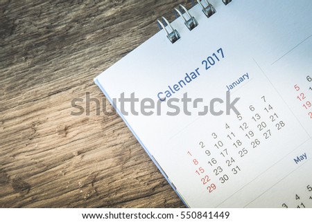 Blurred calendar page 2017 on wood texture.