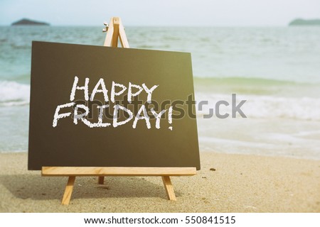 Closeup chalkboard on the beach with text HAPPY FRIDAY! Retro filtered, conceptual image. Royalty-Free Stock Photo #550841515