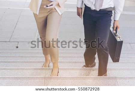 Moment Businessman and Businesswoman running fast upstairs.,image couple leg walking up stairs in city to success,Space for copy text. Royalty-Free Stock Photo #550872928