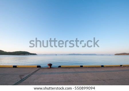 Morning calm ocean view from wharf under blue sky