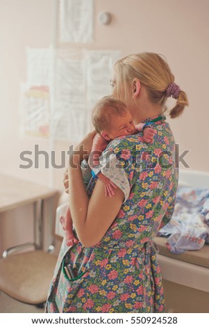 newborn baby and mother in the delivery room, the hospital