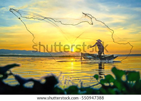 Fishermen fishing in the early morning golden light.Fishermen on a fishing boat.Beautiful sunset.Beautiful sunrise.