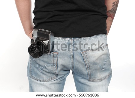 Old photography machine in man's pocket ,isolated on white