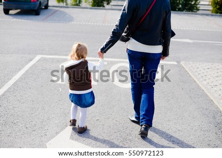 Stop sign and child care. Back view of parent with kid walking on sunny road outdoors background. Childcare, love and safety lifestyle, 