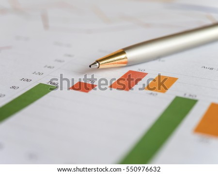 Close pen on business charts and  graph (Selective focus)