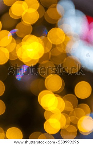 De-focused color background. Yellow Christmas light.