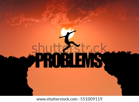 Silhouette businessman Jumping over problems message in sunset background. business concept