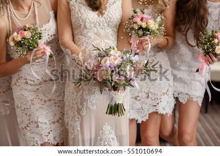 Wedding flowers, bride and bridesmaids holding their bouquets at wedding day. Happy wedding concept Royalty-Free Stock Photo #551010694