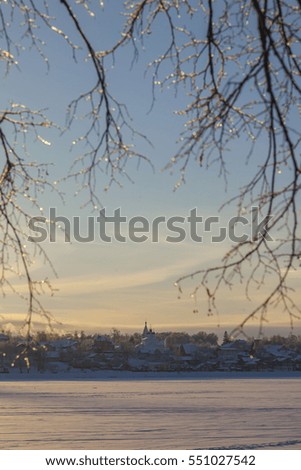 Winter landscape with church and sunset