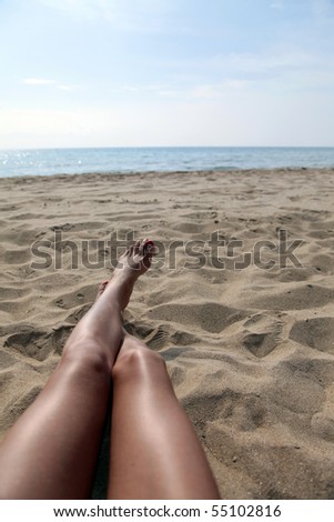 Summertime on Beach.Women Legs on Sand