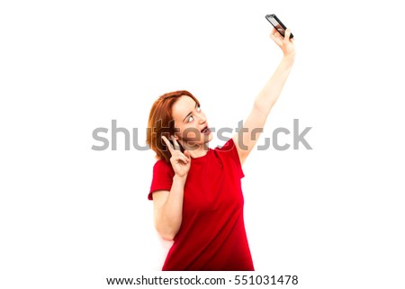 Selfie girl. Red-haired girl holding a phone, selfie photo. The modern concept, fashion selfie photo. Trend. Isolated on white background.