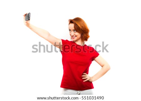 The modern concept of selfie photo. Trend. Young woman holding a phone and makes selfie, isolated on white background. 