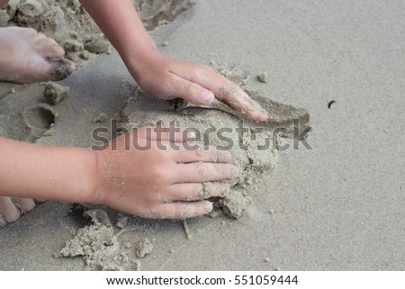 sand therapy. Hands adult and child playing in the sand Royalty-Free Stock Photo #551059444