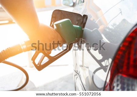 Grey car at gas station being filled with fuel on thailand Royalty-Free Stock Photo #551072056