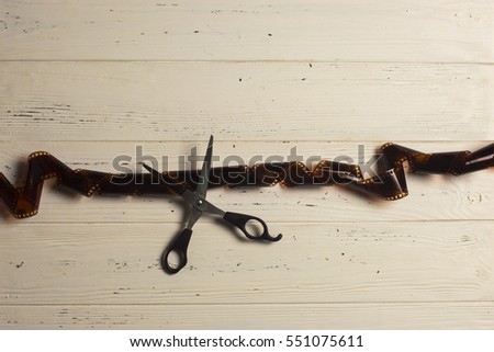 Top view of scissors cutting fillm strip