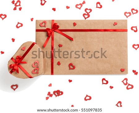 
 Top view of heart shaped box and envelope of brown packing paper with copy space for text on Valentine's day with hearts, isolated on white background. Valentines day idea.