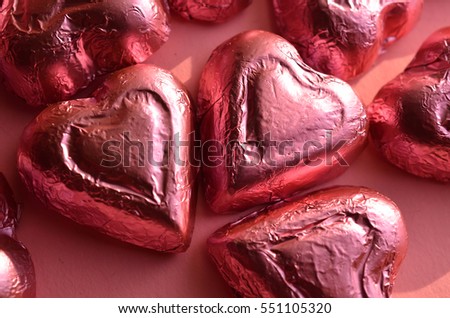 pink foil wrapped chocolate heart shape candy Valentine's Day Royalty-Free Stock Photo #551105320