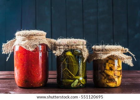 Preserved vegetables on wooden background