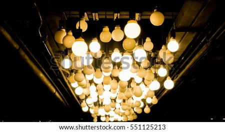 Many of Decorative light lamp bulb glowing on the ceiling , power and energy concept
