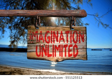 Imagination unlimited motivational phrase sign on old wood with blurred background