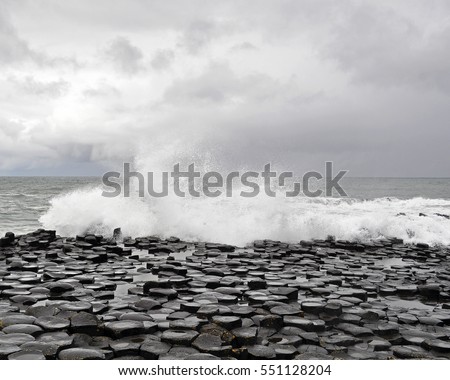 Giants Causeway and Causeway Coast, County Antrim  - Ireland - Waves Splashing Over Interlocking Hexagon Shaped Rocks