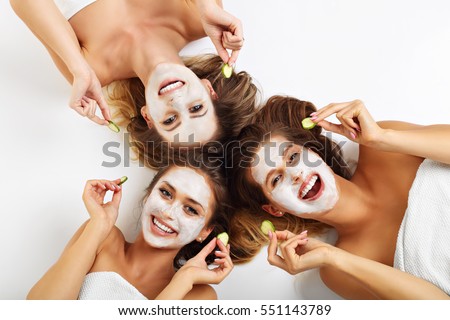 Picture showing three friends with facial masks over white background Royalty-Free Stock Photo #551143789