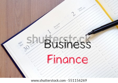 Business finance text concept write on notebook