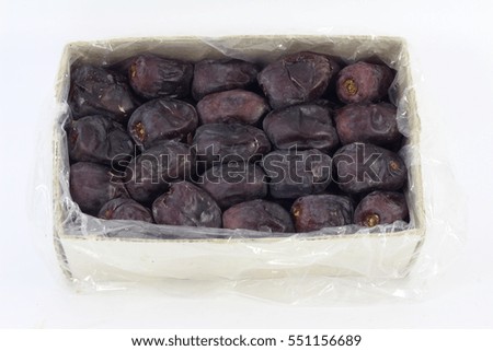 Dried Dates in a box over a white background.