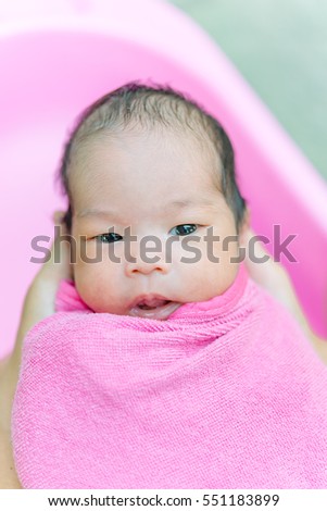 Closeup asian baby in pink towel