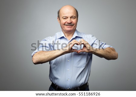 old man making out of hands heart. Doing charity work, take care of the health, or being in love