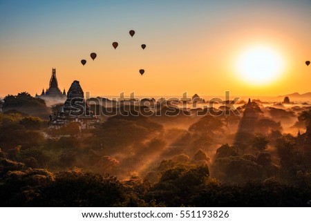 Bagan sunrise in background with hot air balloons, Myanmar Royalty-Free Stock Photo #551193826