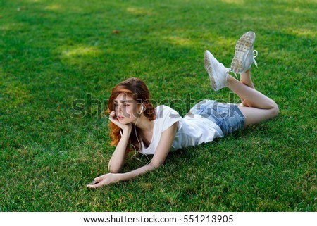 Young woman takes a break from walking on the grass