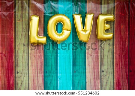 Word LOVE with pallet print background on backdrop.