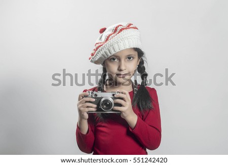 beautiful little girl with retro camera in hand