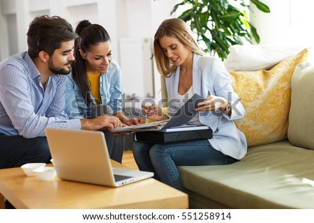 Real Estate agent offer home ownership and life insurance to young couple. Royalty-Free Stock Photo #551258914
