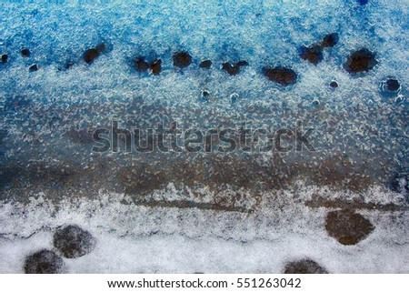 Melting spring ice on river filled with light and colors