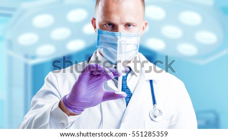 Experienced doctor in operating room. Light background