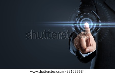Business man touching virtual interface button on dark background with copy space Royalty-Free Stock Photo #551285584