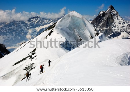 Group of backcountry skiers (ski touring), on background the Matterhorn west alps, Europe.